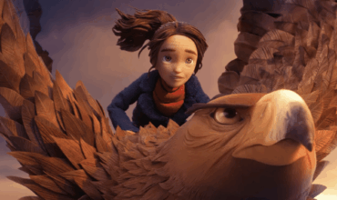 A girl rides a large eagle through the sky in a scene from Wildwood.